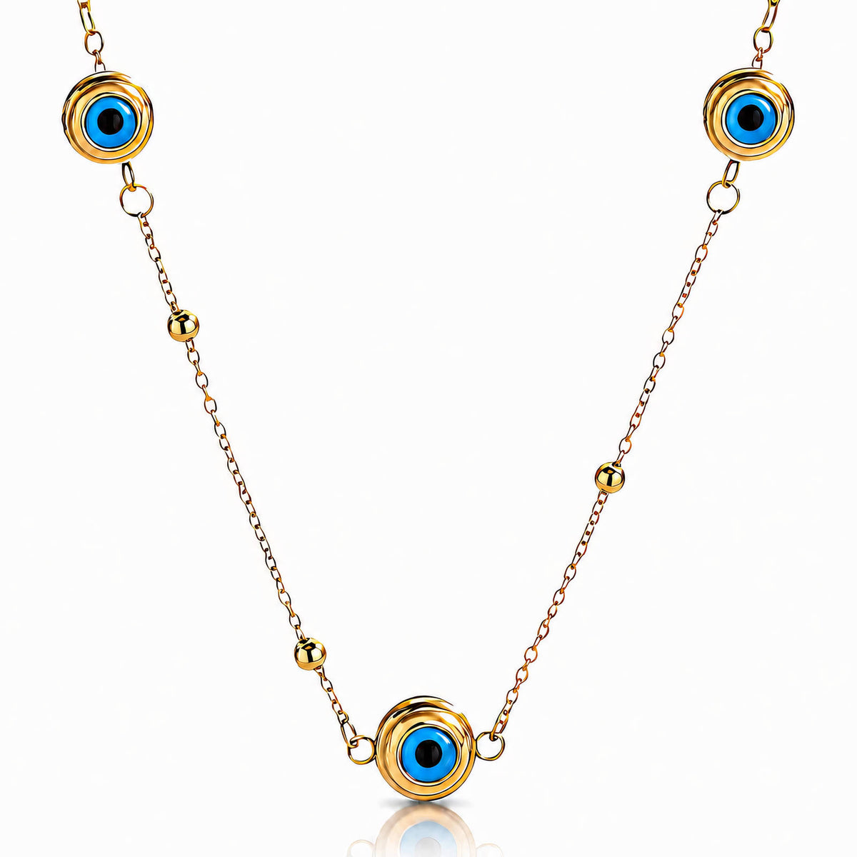 Evil Eye Station Necklace: the three evil-eye stations on white, gold tone