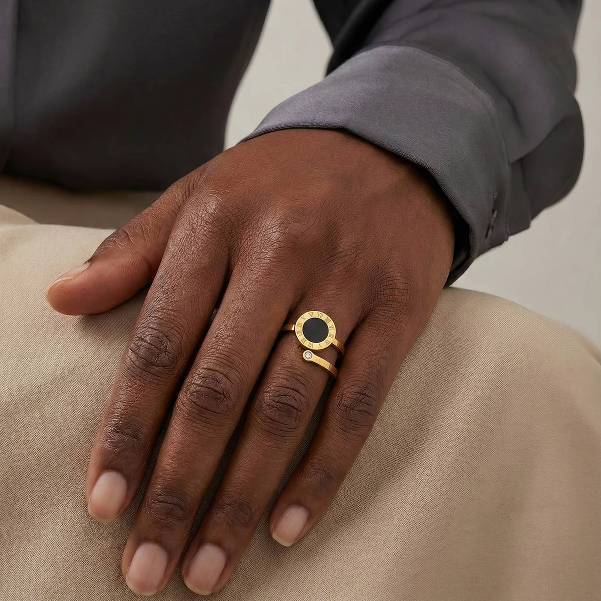 Black Disc Wrap Ring: worn on the hand, gold tone with black disc