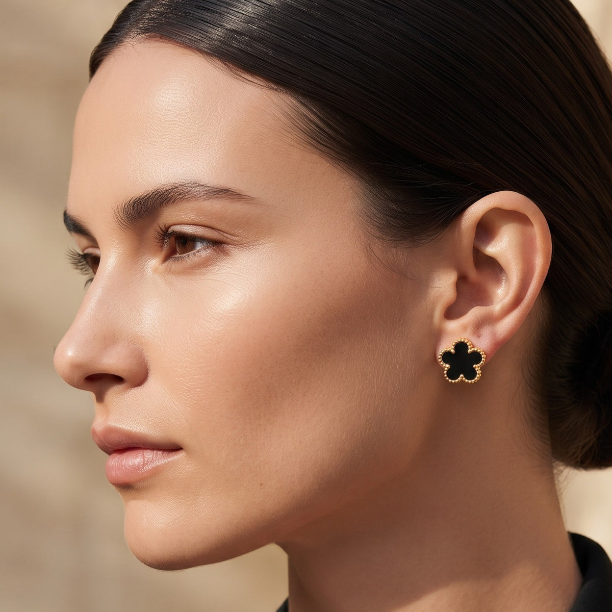 Black flower studs, worn