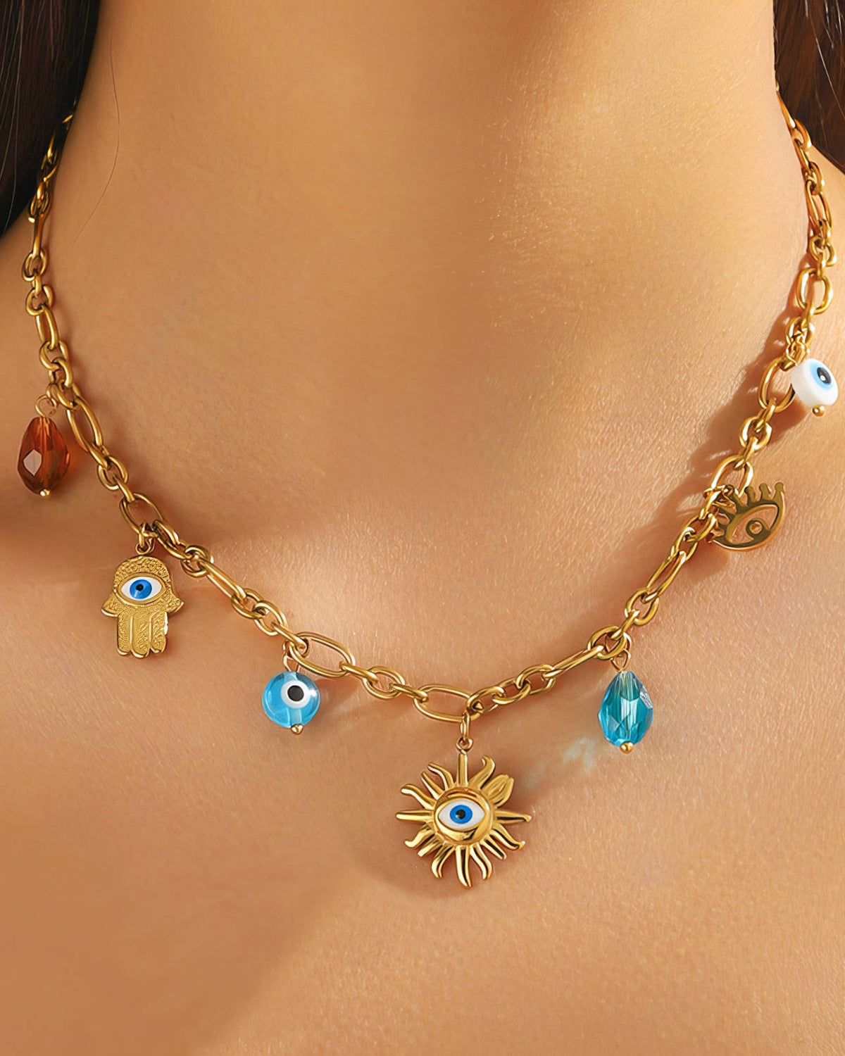 Evil Eye Charm Necklace: worn at the neckline to show the length and charm spacing, gold tone