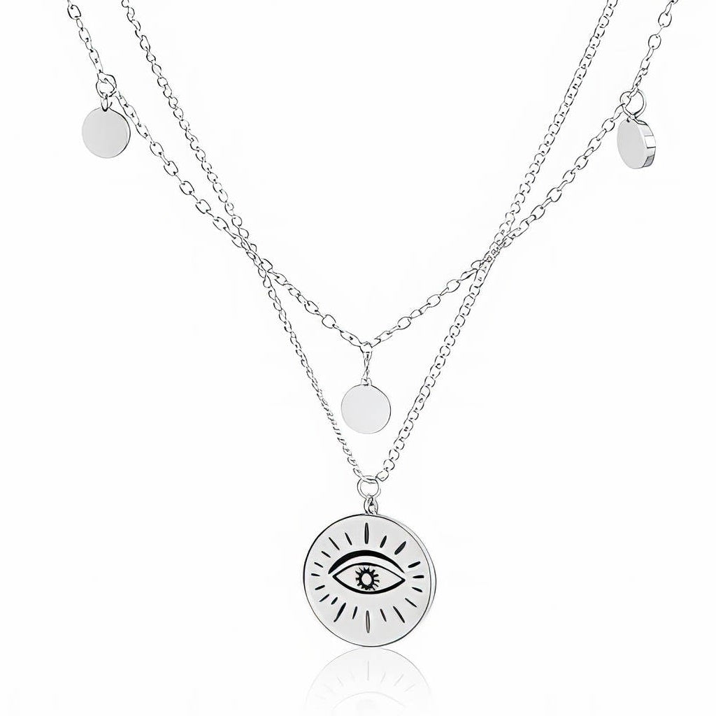 Silver-Tone Evil Eye Necklace: two silver-tone chains with small discs and an evil eye coin, close-up on white
