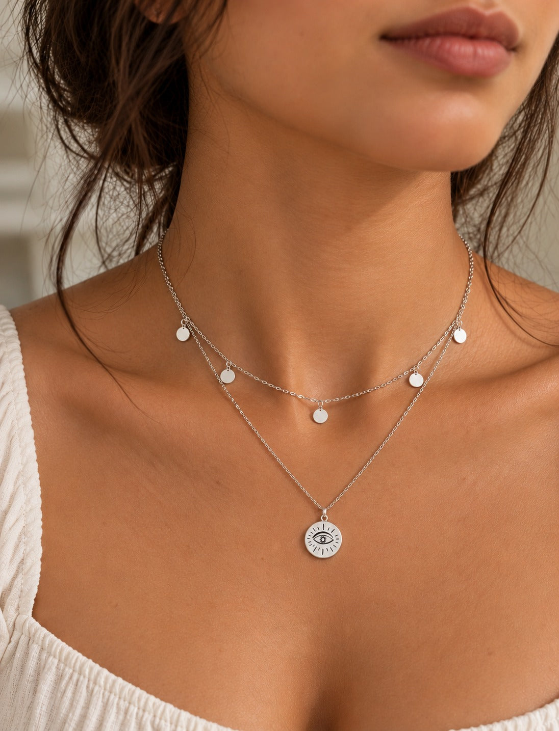 Silver-Tone Evil Eye Necklace, worn at the neckline