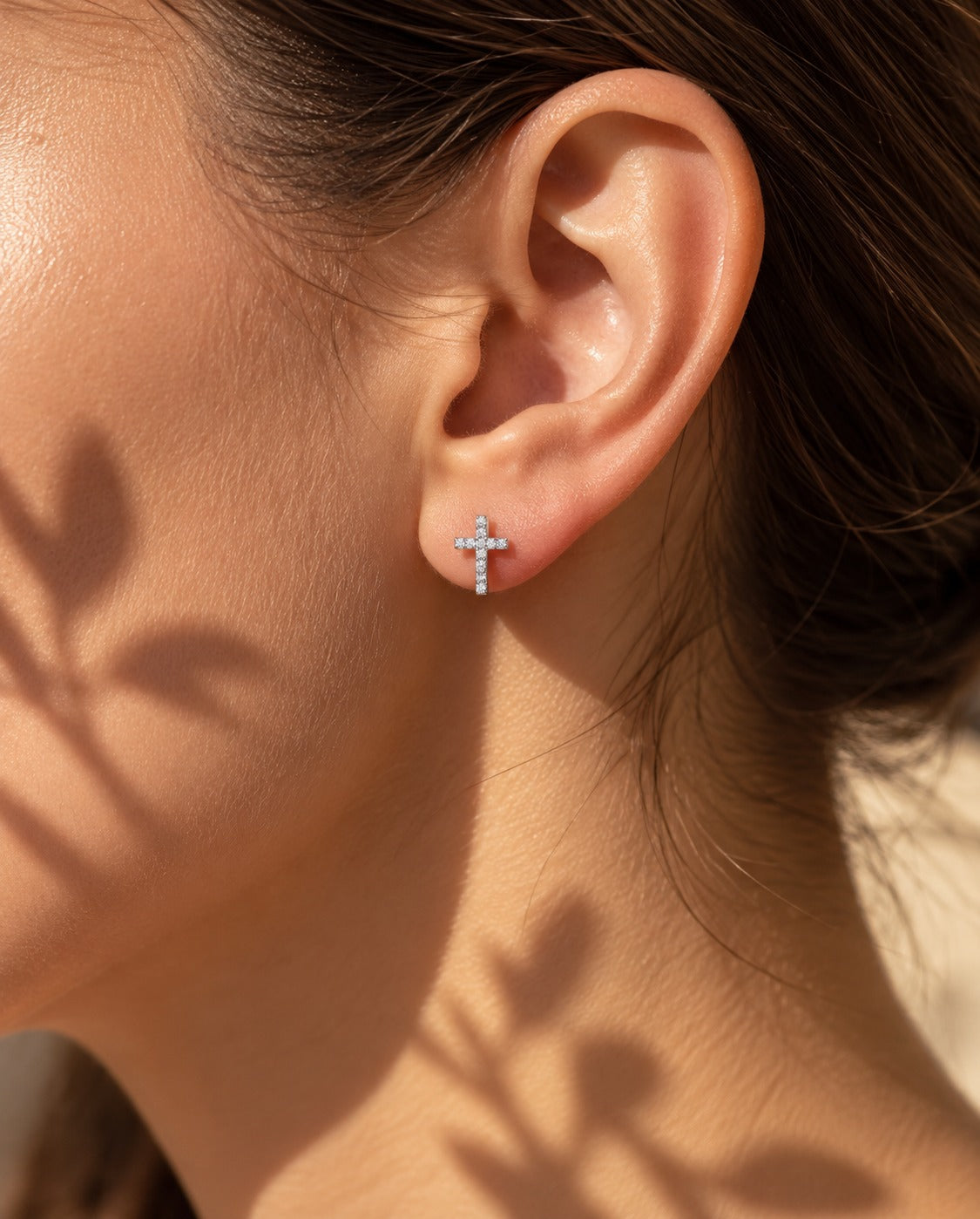 Silver-Tone Pavé Cross Studs, worn on the ear