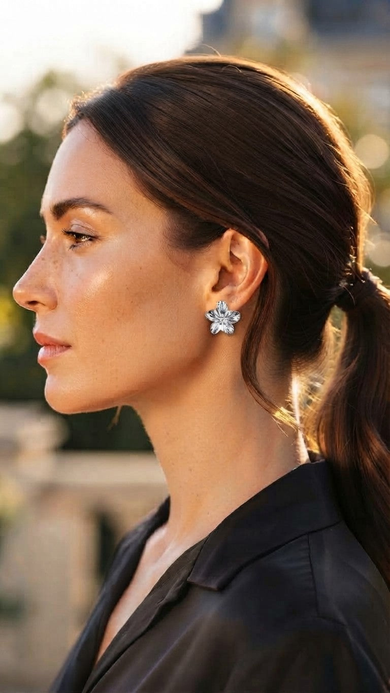 Silver sculpted flower studs, worn
