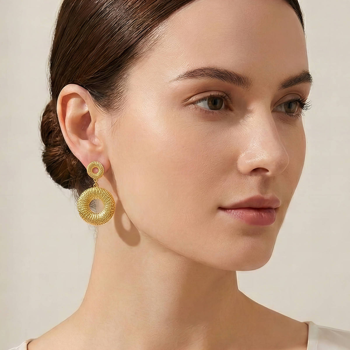 Textured Double Circle Drop Earrings: worn, showing their size on a model, gold tone