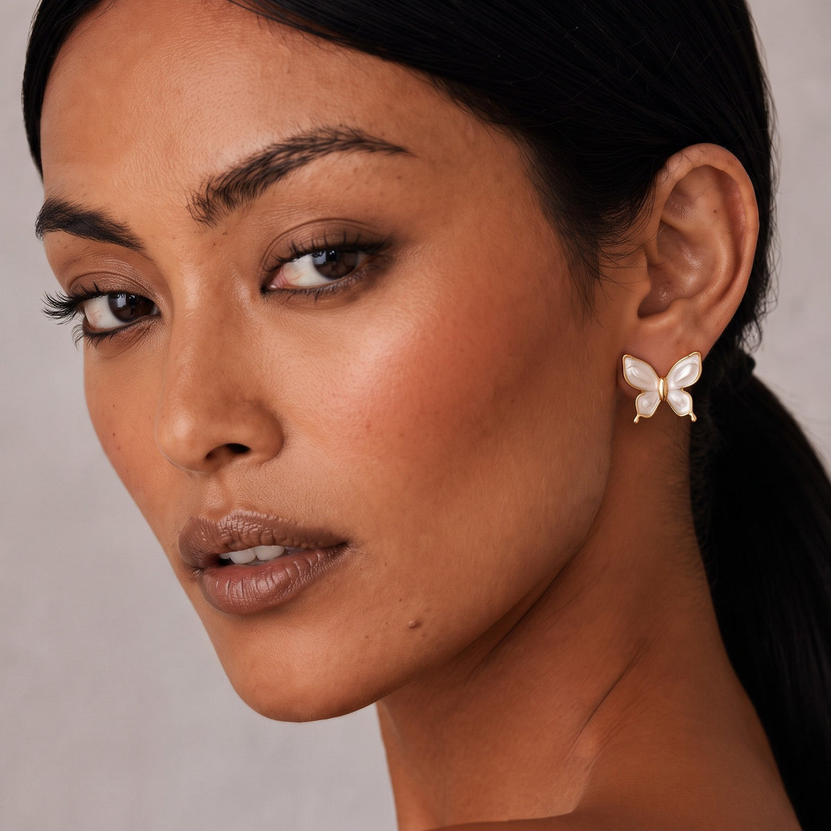 White butterfly studs, worn